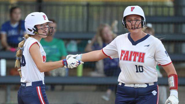 Grapevine Faith center fielder Michaela Hamilton (16) congratulates Elle Powers (10) after Powers scored a run during a softball game at Oak Grove Park in Grapevine, Texas, Tuesday, March 31, 2026.